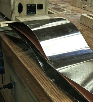 Stainless steel slats for bending ukulele sides, Sandwich of slats, heating blanket and wood side.